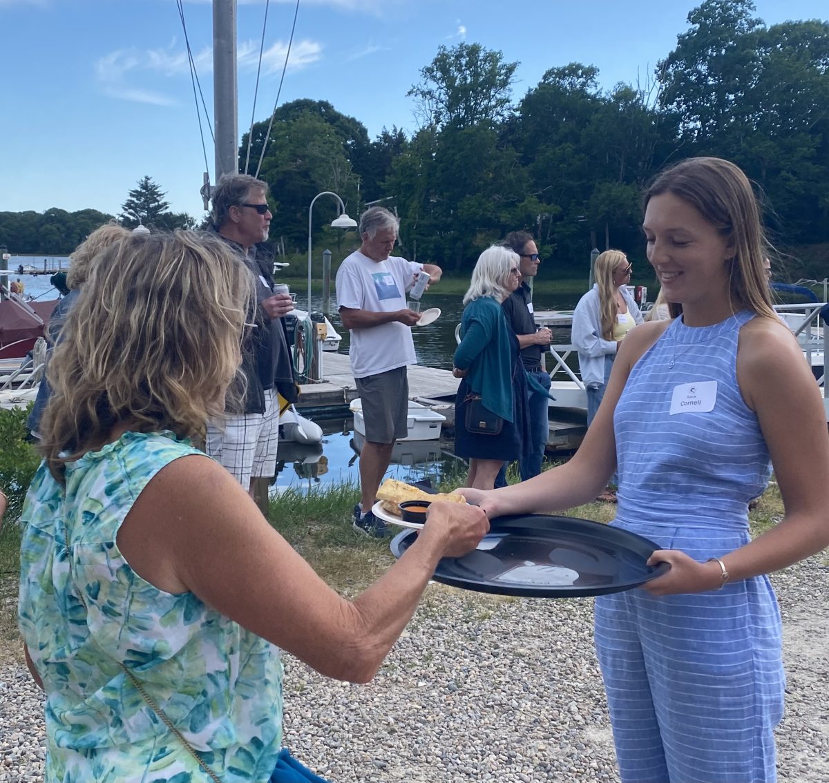 Sara Cornell, an intern at the Fishermen's Alliance, hands out one of the last lobster grilled cheese sandwiches to a grateful attendee.