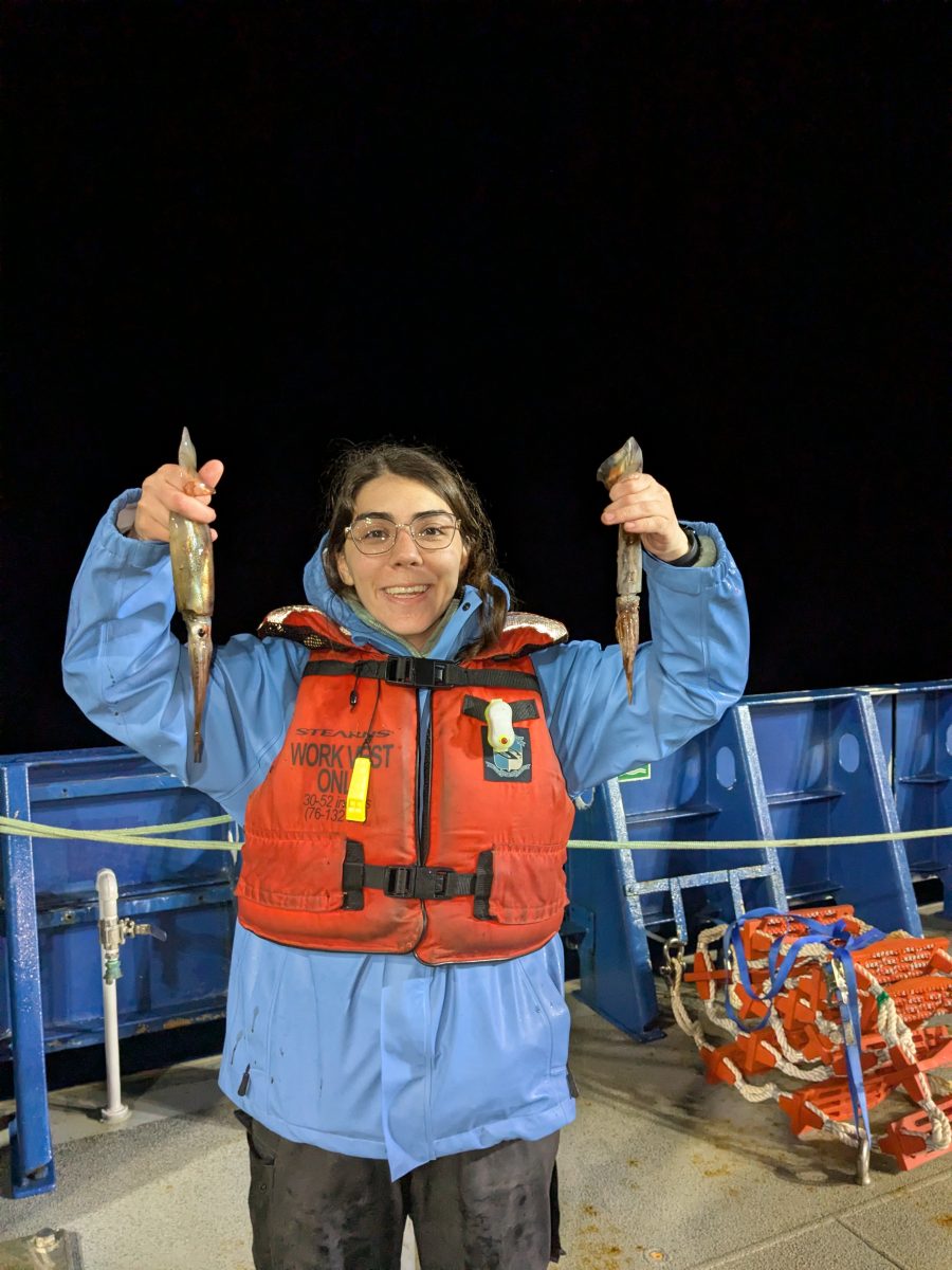 woman holding up a squid in each hand